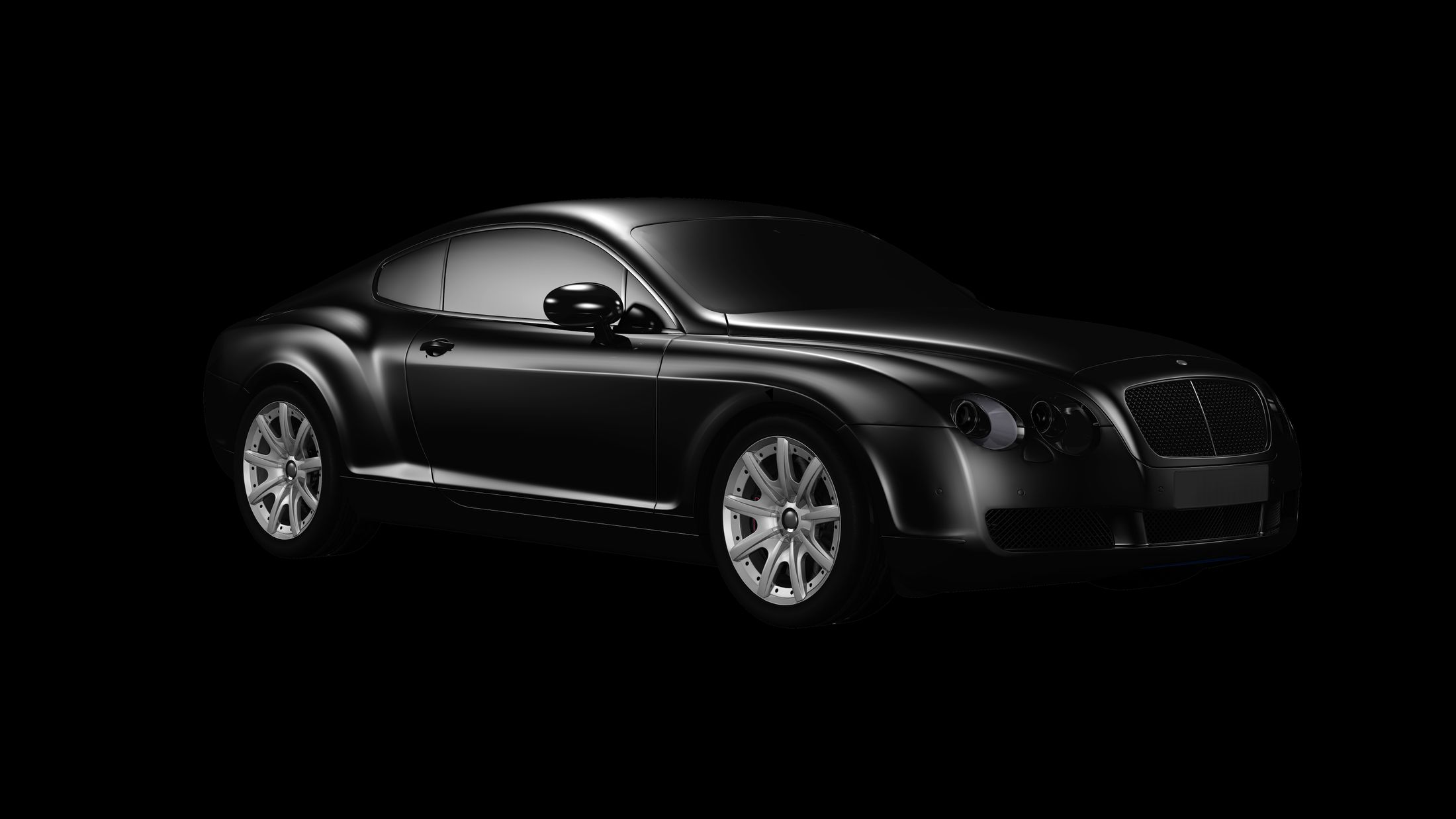 Black luxury coupe with sculpted bodywork in a dark studio