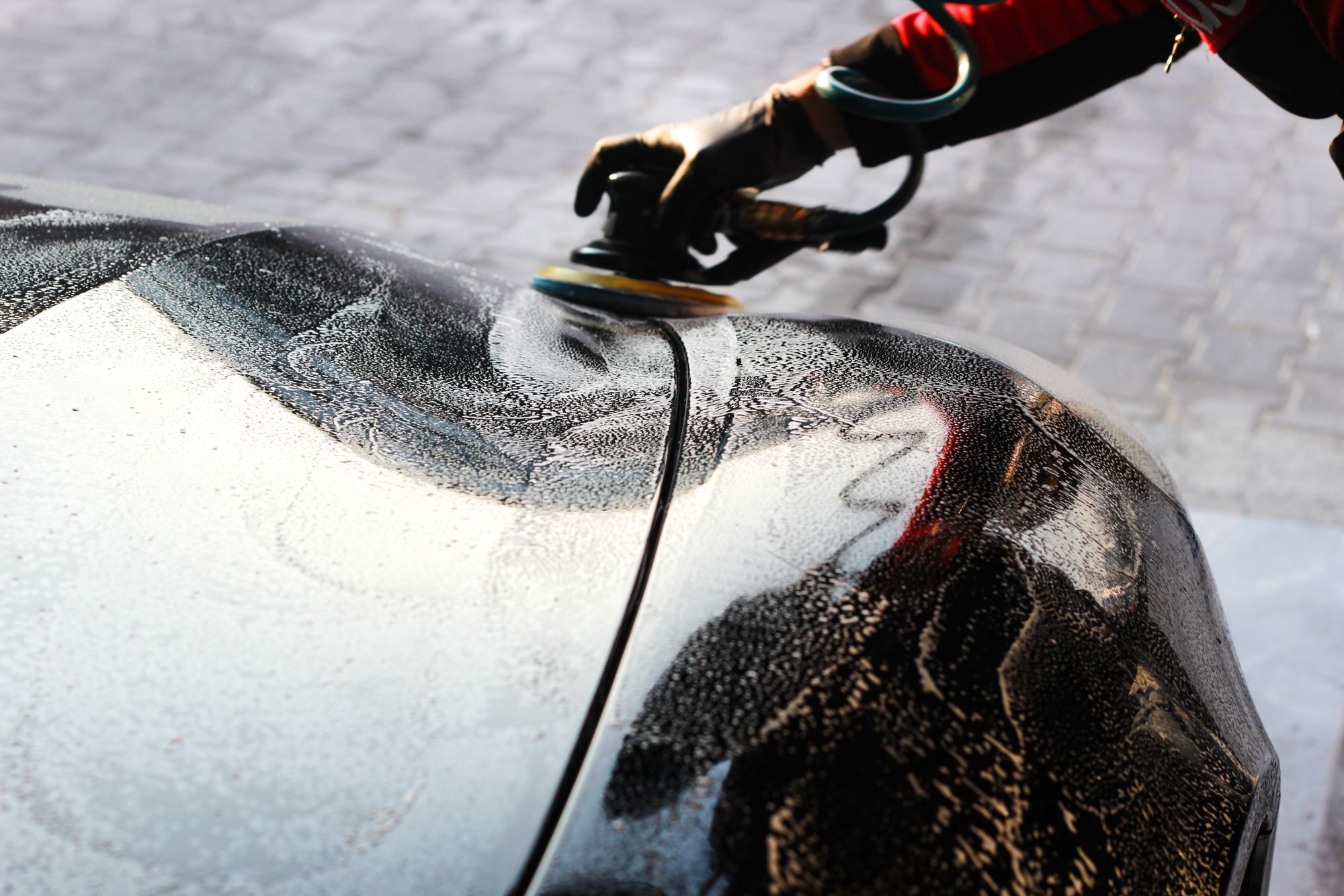 Careful hand finishing on a vehicle panel